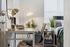 Bright and inviting home office with modern desk, stylish chair, and elegant lighting, complemented by potted plants and soft textures.