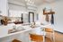 Modern open-concept kitchen with sleek stainless steel appliances and elegant dining bar setup.