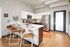 Modern kitchen with sleek stainless steel appliances, elegant island seating, and stylish wooden flooring.