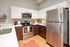Modern kitchen with sleek stainless steel appliances, elegant cabinetry, and a cozy, inviting atmosphere.
