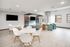 Modern living room with sleek furniture, large windows, and stylish decor, perfect for entertaining.