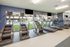 Modern fitness center featuring state-of-the-art treadmills, step machines, and a view of the pool area for a premium workout experience.