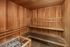 Luxurious wooden sauna room with elegant benches and warm ambiance for ultimate relaxation.