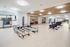 Modern fitness studio featuring sleek exercise equipment, elegant design, and ample space for workouts.