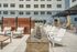 Inviting outdoor patio area with modern seating, stone fire feature, and urban terrace design.