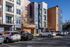 Modern apartment complex with colorful exterior and ample parking, showcasing vibrant urban living.