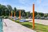 Vibrant outdoor area featuring hammocks and a sandy play zone, perfect for relaxation under the sunny sky.