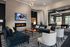 Luxurious modern living room with chic seating, stylish decor, and a cozy fireplace, perfect for relaxation and entertainment.