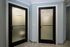 Inviting wellness area showcasing frosted glass doors leading to a shower and steam room, accented by sleek modern design.