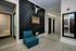 Modern apartment hallway featuring elegant textured wallpaper, contemporary decor, and a stylish seating area.