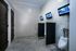 Modern restroom featuring sleek urinals, stylish tile flooring, and mounted flat-screen TVs for a contemporary touch.