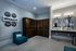 Modern lounge area with sleek cabinetry, elegant wall decor, and plush seating, ideal for relaxation and socializing.
