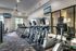 Modern fitness center with state-of-the-art equipment, featuring multiple treadmills, stylish interiors, and natural light.