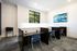 Contemporary study area featuring sleek workstations, comfortable chairs, and a scenic view from the window, perfect for productivity.