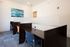 Modern workspace featuring individual cubicles with comfortable chairs and elegant decor.