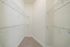 Spacious and bright walk-in closet with ample shelving for organized storage.