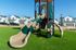 Inviting playground surrounded by modern residential homes on a sunny day.
