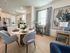 Bright open-concept kitchen and dining area featuring modern decor, elegant dining set, and stainless steel appliances.