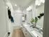 Modern bathroom with elegant granite countertops, dual sinks, and stylish decor featuring lush greenery and contemporary lighting.