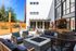 Chic outdoor patio with elegant seating, modern fire pit, and BBQ grill, perfect for relaxation and entertaining.