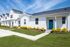 Charming suburban homes with vibrant blue doors, manicured lawns, and clear skies offering picturesque curb appeal.