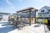Inviting outdoor patio featuring stylish pergola, modern dining area, and built-in BBQ grills perfect for gatherings.