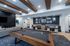 Modern entertainment lounge featuring a sleek billiard table, stylish seating area, and contemporary wall art.