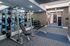 Modern apartment gym with state-of-the-art fitness equipment, free weights, and spacious workout area.