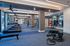 State-of-the-art fitness center featuring modern cardio equipment, strength training machines, and ample open space.