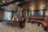 Modern and elegant communal living space featuring plush seating, stylish bar stools, and a sleek marble counter, perfect for entertaining.