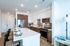 Modern kitchen with sleek countertops, stylish cabinetry, and stainless steel appliances in a chic open-concept design.