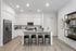 Modern kitchen with sleek white cabinetry, stainless steel appliances, and a stylish island with green bar stools, perfect for entertaining.