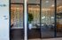 Chic conference rooms with tropical floral wallpaper and elegant glass doors, perfect for meetings and collaborations.