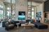Luxurious open-concept living area with high ceilings, stylish sectional sofas, modern fireplace, and elegant decor.