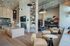 Luxurious open-plan living space with a grand kitchen island, cozy seating, modern fireplace, and stylish decor.