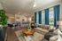 Modern open-concept living space with cozy seating, elegant kitchen island, and large windows with blue curtains.