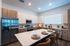Luxurious modern kitchen with sleek stainless steel appliances, elegant island seating, and abundant natural light.