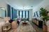 Elegant living room featuring a cozy beige sofa, vibrant blue curtains, and stylish decor accents in a modern apartment.