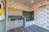 Chic pet washing station with playful dog-themed wallpaper, modern cabinetry, and sleek tile flooring.