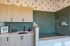 Chic and modern pet grooming area with stylish cabinetry and sleek green tiles.