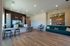 Inviting and modern lobby with stylish decor, featuring a sleek wood floor, vibrant green seating, and elegant ambient lighting.