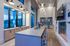 Luxurious modern kitchen with sleek countertops, stylish pendant lights, cozy fireplace, and panoramic windows offering stunning views.