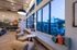 Elegant lounge area with modern furniture and large windows showcasing an inviting outdoor view, perfect for relaxation and social gatherings.