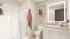 Modern bathroom with elegant glass shower, illuminated mirror, and stylish decor, offering a serene and luxurious ambiance.
