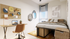 Modern bedroom with chic decor, featuring a cozy bed, stylish workspace, and unique decorative wall mirrors.