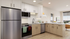 Modern kitchen with sleek stainless steel appliances, granite countertops, and stylish cabinetry in a bright, open living space.