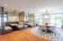 Modern communal space with sleek booth seating, elegant lighting, and a vibrant round rug, perfect for social gatherings or cozy study sessions.