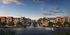 Elegant apartment complex at sunset with lush landscaping and modern architectural design.