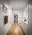 Elegant bathroom with sleek white cabinets, modern fixtures, and a spacious walk-in closet.