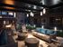 Chic and inviting apartment courtyard with cozy seating, glowing fire pit, and ambient lighting for a relaxing evening atmosphere.